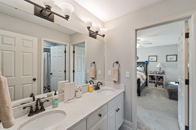 1720 Cedarwood Cir, Clive, IA 50325 - bathroom featuring connected bathroom, double vanity, and ceiling fan