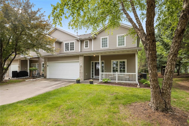 1117 S 52nd St Unit 1705, West Des Moines, IA 50265 - traditional-style home featuring covered porch, driveway, a front lawn, and a garage