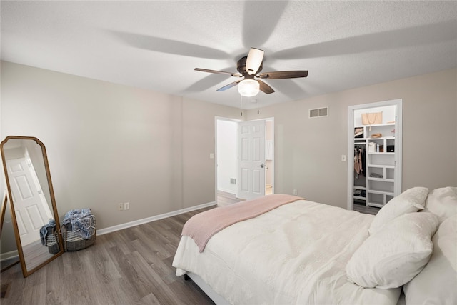 1117 S 52nd St Unit 1705, West Des Moines, IA 50265 - bedroom featuring wood finished floors, a walk in closet, and a ceiling fan