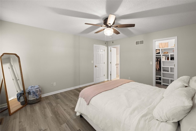 1117 S 52nd St Unit 1705, West Des Moines, IA 50265 - bedroom with wood finished floors, a walk in closet, and a ceiling fan
