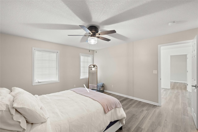 1117 S 52nd St Unit 1705, West Des Moines, IA 50265 - bedroom featuring light wood finished floors, a textured ceiling, and ceiling fan