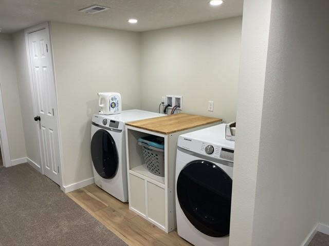 316 NW Linden St, Ankeny, IA 50023 - laundry room with washer and clothes dryer, recessed lighting, and light wood-style floors