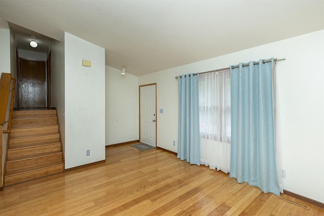 3719 SE 20th St, Des Moines, IA 50320 - spare room featuring light wood-type flooring and stairway