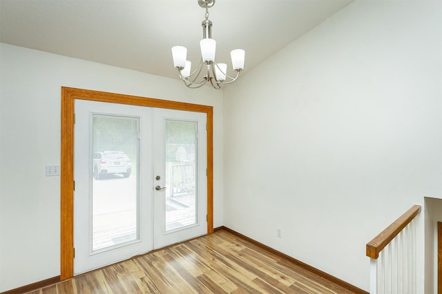 3719 SE 20th St, Des Moines, IA 50320 - doorway with french doors, a chandelier, and light wood finished floors