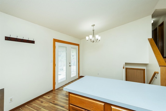 3719 SE 20th St, Des Moines, IA 50320 - dining room featuring light wood finished floors, french doors, and a chandelier