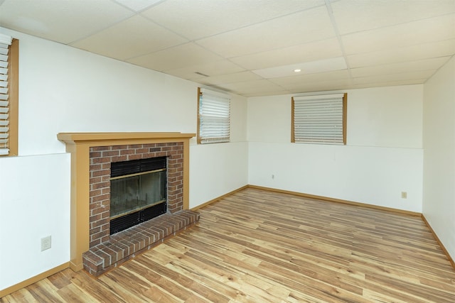 3719 SE 20th St, Des Moines, IA 50320 - unfurnished living room featuring a paneled ceiling, a fireplace, wood finished floors, and recessed lighting