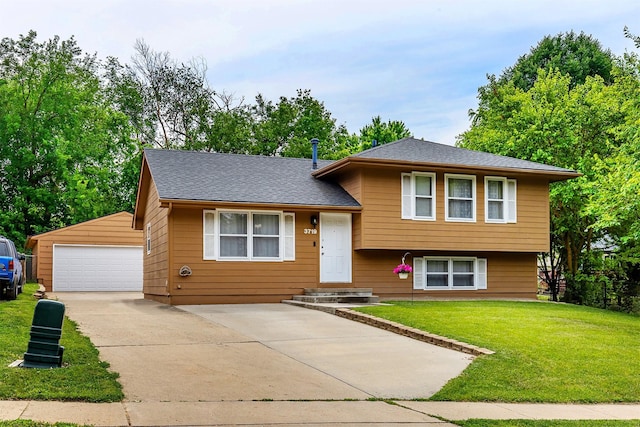3719 SE 20th St, Des Moines, IA 50320 - tri-level home with a detached garage, an outbuilding, and a front lawn