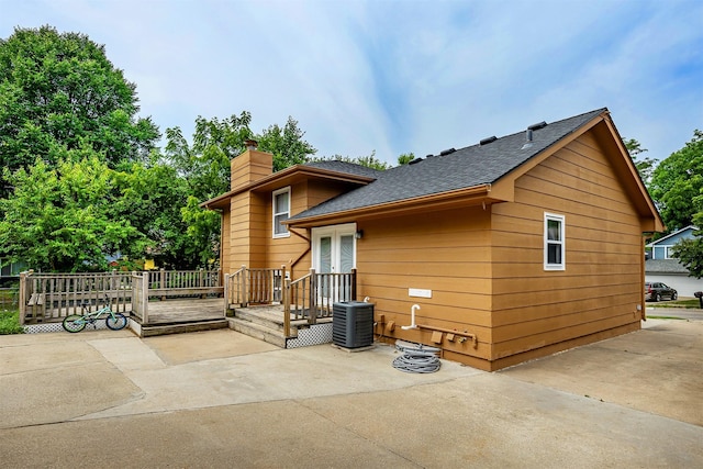 3719 SE 20th St, Des Moines, IA 50320 - back of house featuring a chimney, roof with shingles, a deck, and a patio area