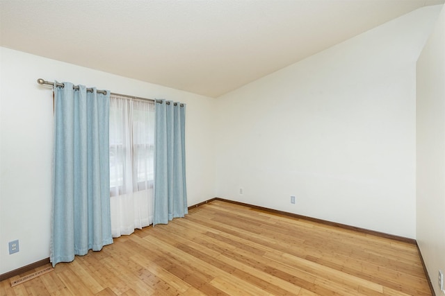 3719 SE 20th St, Des Moines, IA 50320 - empty room featuring light wood finished floors and lofted ceiling
