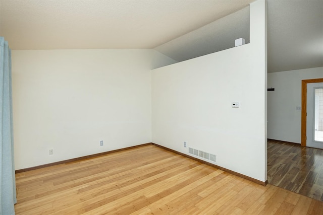 3719 SE 20th St, Des Moines, IA 50320 - empty room with vaulted ceiling and wood finished floors