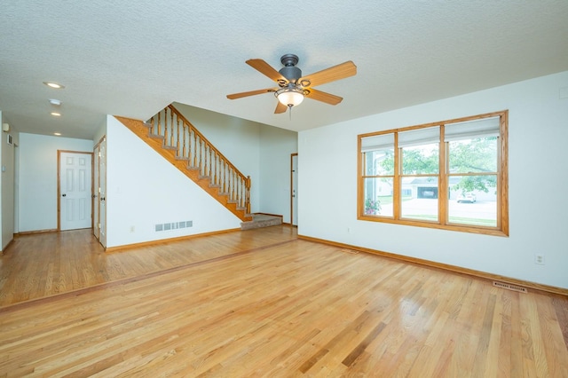 117 4th St NW, Altoona, IA 50009 - unfurnished living room with stairs, ceiling fan, wood finished floors, a textured ceiling, and recessed lighting