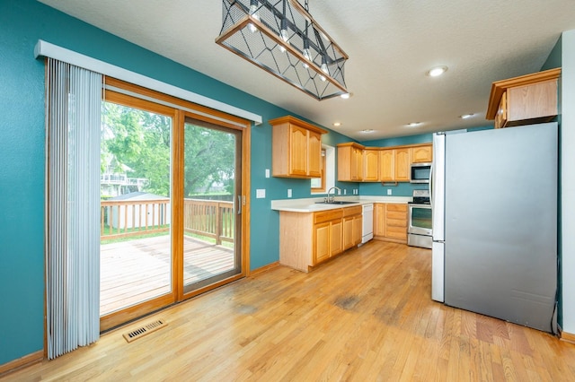 117 4th St NW, Altoona, IA 50009 - kitchen with appliances with stainless steel finishes, light wood-style floors, light countertops, light brown cabinets, and recessed lighting