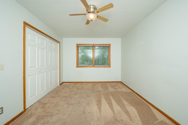 117 4th St NW, Altoona, IA 50009 - unfurnished bedroom with light carpet, a closet, and ceiling fan