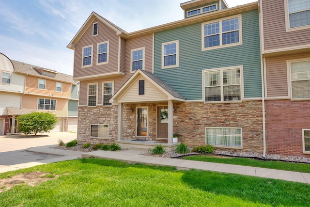 3600 SE Glenstone Dr Unit 308, Grimes, IA 50111 - view of property with stone siding and a front lawn