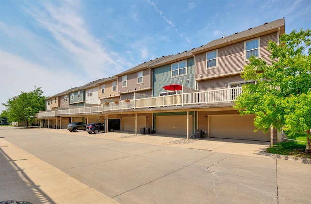 3600 SE Glenstone Dr Unit 308, Grimes, IA 50111 - view of building exterior with a residential view, a garage, and driveway