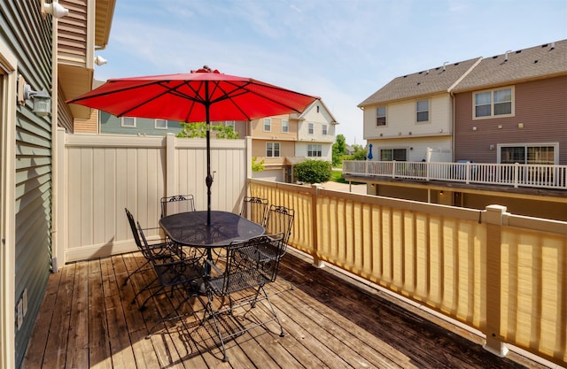 3600 SE Glenstone Dr Unit 308, Grimes, IA 50111 - wooden deck featuring outdoor dining area and a residential view