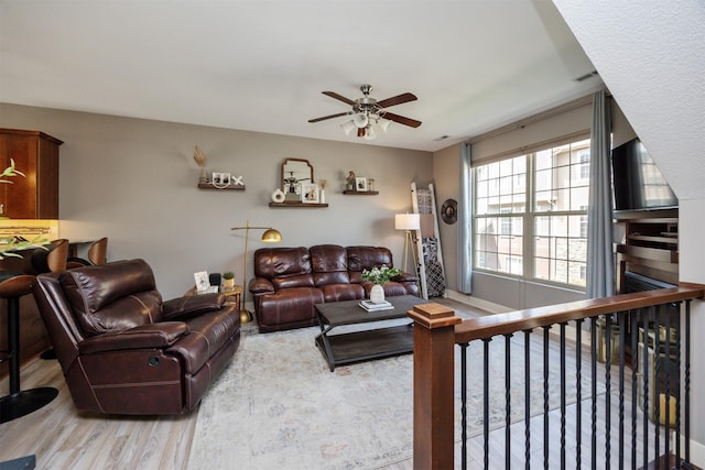 3600 SE Glenstone Dr Unit 308, Grimes, IA 50111 - living area with a ceiling fan and wood finished floors