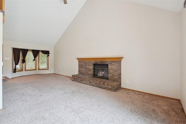 725 SE Peterson Dr, Ankeny, IA 50021 - unfurnished living room with high vaulted ceiling, carpet, and a brick fireplace