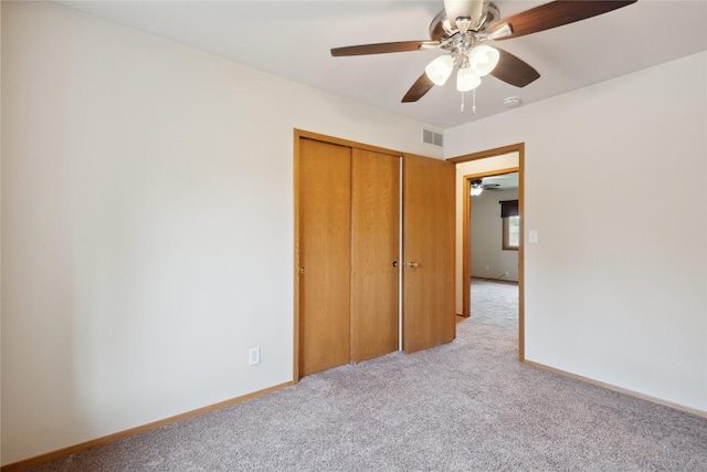 725 SE Peterson Dr, Ankeny, IA 50021 - unfurnished bedroom featuring light colored carpet, a closet, and a ceiling fan