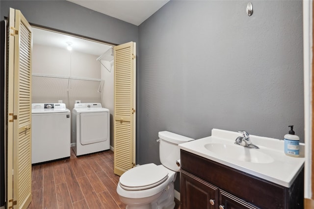 725 SE Peterson Dr, Ankeny, IA 50021 - bathroom with washer and dryer, a closet, vanity, and wood finished floors