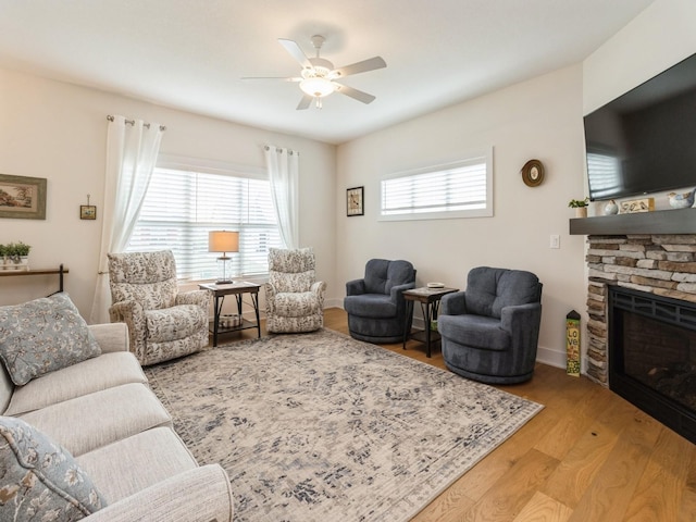 2206 SW Westwood St, Ankeny, IA 50023 - living area with a ceiling fan, wood finished floors, and a fireplace