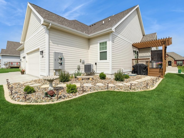 2206 SW Westwood St, Ankeny, IA 50023 - rear view of house with a pergola, concrete driveway, a lawn, and a shingled roof
