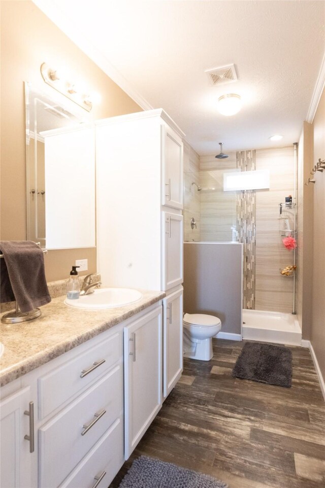 2006 10th St, Eldora, IA 50627 - full bathroom featuring double vanity, walk in shower, and wood finished floors