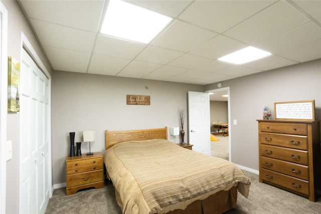 2006 10th St, Eldora, IA 50627 - bedroom with light colored carpet, a drop ceiling, and a closet