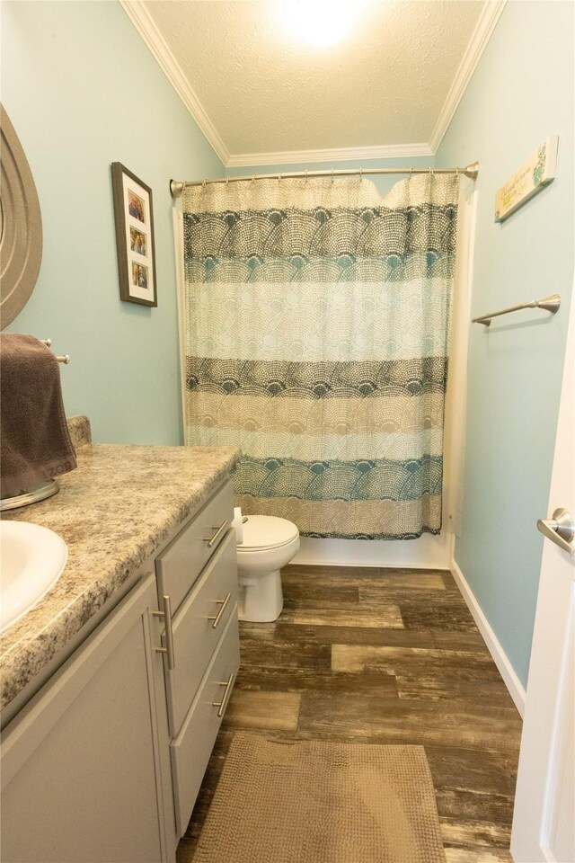 2006 10th St, Eldora, IA 50627 - full bathroom featuring vanity, wood finished floors, and ornamental molding