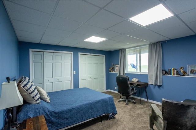 2006 10th St, Eldora, IA 50627 - bedroom featuring carpet, multiple closets, and a drop ceiling