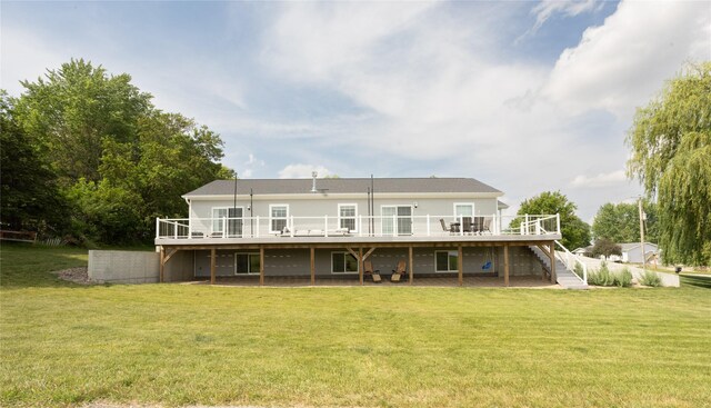 2006 10th St, Eldora, IA 50627 - rear view of house with stairs, a wooden deck, and a yard