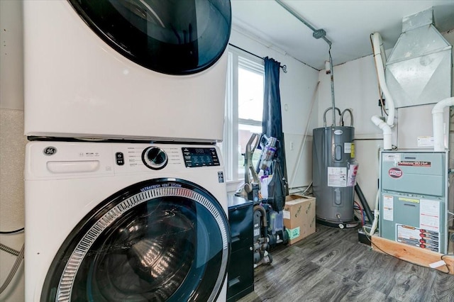 911 E 1st Ave, Indianola, IA 50125 - washroom with stacked washing machine and dryer, electric water heater, wood finished floors, and heating unit