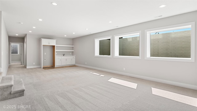780 NE Badger Ln, Waukee, IA 50263 - unfurnished living room with light colored carpet and recessed lighting