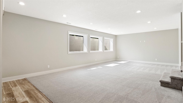 780 NE Badger Ln, Waukee, IA 50263 - spare room with recessed lighting, light colored carpet, and light wood-type flooring