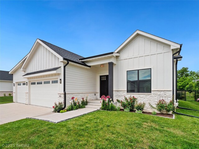 780 NE Badger Ln, Waukee, IA 50263 - modern inspired farmhouse with board and batten siding, stone siding, an attached garage, driveway, and roof with shingles