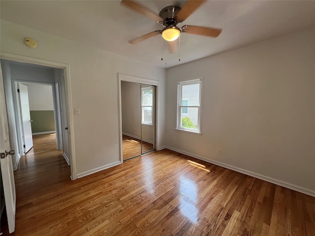 2712 49th St, Des Moines, IA 50310 - unfurnished bedroom with a closet, wood finished floors, and ceiling fan