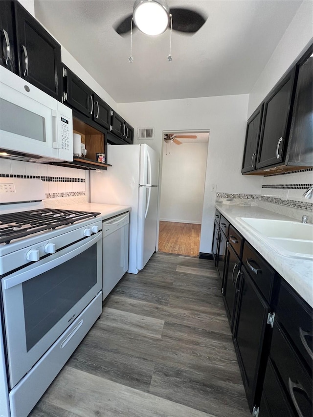 2712 49th St, Des Moines, IA 50310 - kitchen featuring white appliances, a ceiling fan, dark cabinetry, light countertops, and dark wood-style floors