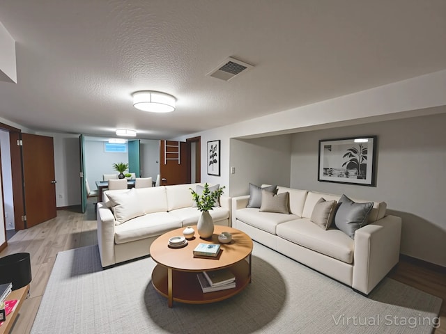 2712 49th St, Des Moines, IA 50310 - living room featuring light wood-style floors and a textured ceiling