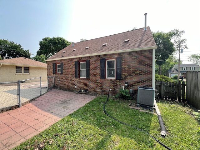 2712 49th St, Des Moines, IA 50310 - rear view of property featuring roof with shingles, brick siding, a patio, a fenced backyard, and a gate