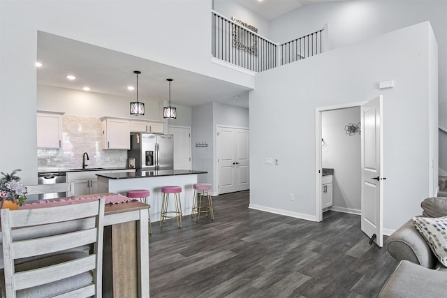 481 10th St, Waukee, IA 50263 - kitchen featuring stainless steel appliances, dark wood-type flooring, a center island, recessed lighting, and white cabinets