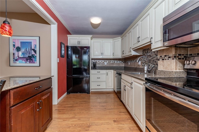 3663 Grand Ave Unit 604, Des Moines, IA 50312 - kitchen with stainless steel appliances, backsplash, light wood-type flooring, dark stone countertops, and white cabinets