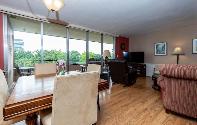 3663 Grand Ave Unit 604, Des Moines, IA 50312 - dining space with wood finished floors, healthy amount of natural light, and wainscoting