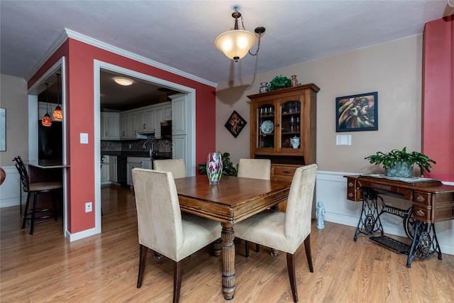 3663 Grand Ave Unit 604, Des Moines, IA 50312 - dining room featuring light wood-style flooring and crown molding