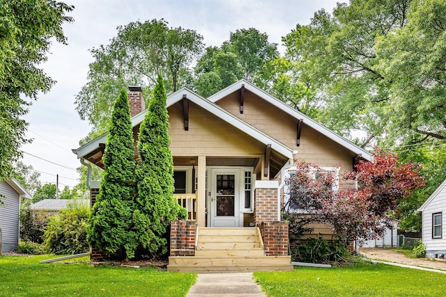 1108 Creston Ave, Des Moines, IA 50315 - view of front of home with a chimney, a front lawn, and a porch