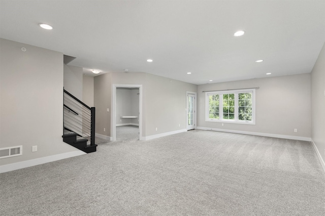 14186 Pinnacle Pointe Dr Unit 86, Clive, IA 50325 - unfurnished living room with carpet flooring, recessed lighting, and stairs