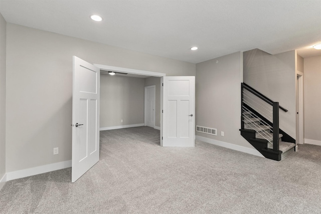 14186 Pinnacle Pointe Dr Unit 86, Clive, IA 50325 - basement featuring carpet floors, stairway, and recessed lighting