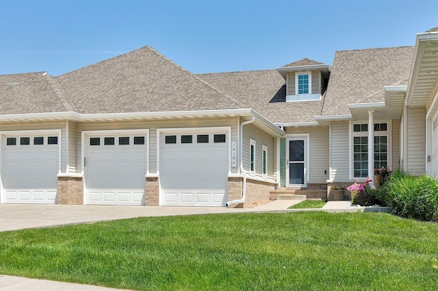 14186 Pinnacle Pointe Dr Unit 86, Clive, IA 50325 - view of front facade with an attached garage, concrete driveway, brick siding, and a shingled roof