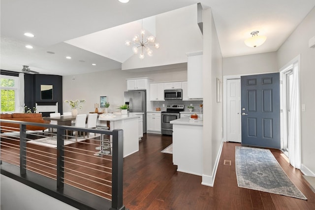 14186 Pinnacle Pointe Dr Unit 86, Clive, IA 50325 - kitchen with appliances with stainless steel finishes, light countertops, recessed lighting, white cabinets, and dark wood finished floors