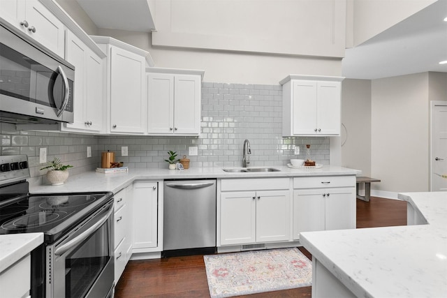 14186 Pinnacle Pointe Dr Unit 86, Clive, IA 50325 - kitchen with stainless steel appliances, white cabinets, dark wood finished floors, decorative backsplash, and recessed lighting