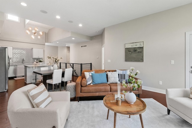 14186 Pinnacle Pointe Dr Unit 86, Clive, IA 50325 - living area featuring a chandelier, wood finished floors, recessed lighting, and vaulted ceiling